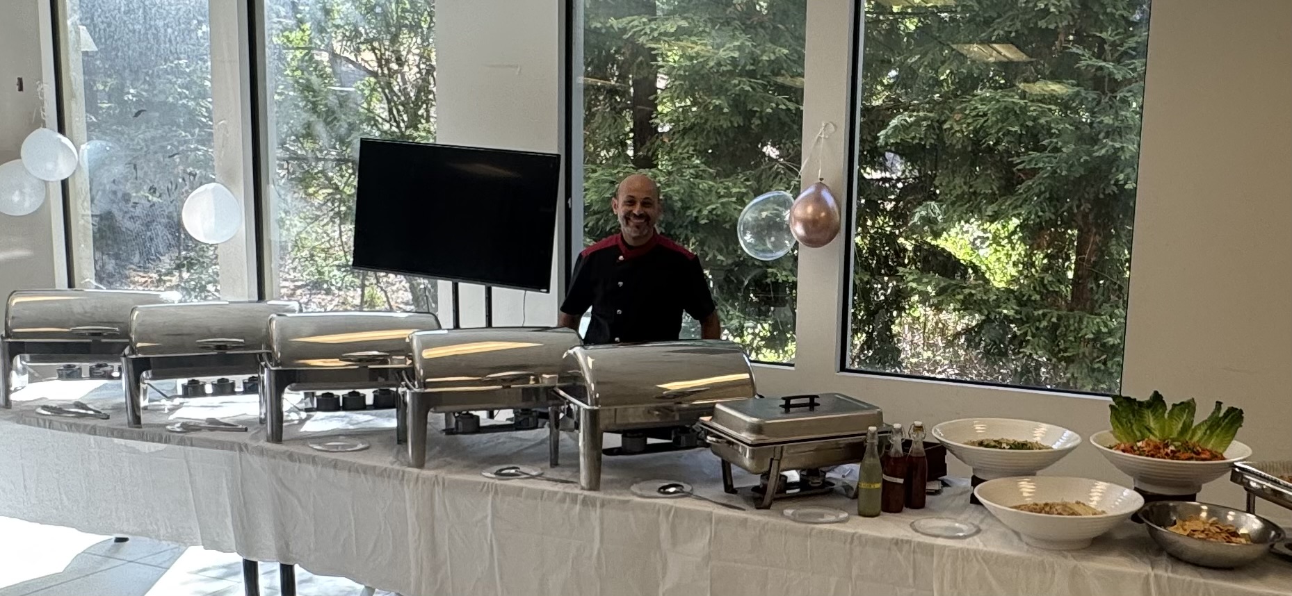 Egyptian Grill buffet with serving trays and salads at an indoor event