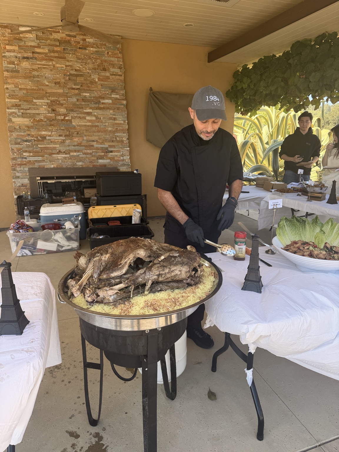 Egyptian Grill chef serving lamb over rice at an outdoor event
